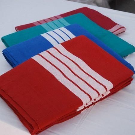 Hospital bed sheets in red, green and blue with white stripes